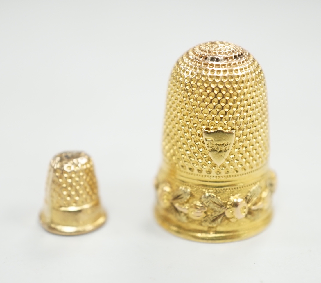 A French yellow metal (18ct poincon mark) thimble, 22mm, 5.4 grams and a tiny 1960's 9ct gold thimble, 9mm, 0.5 grams.